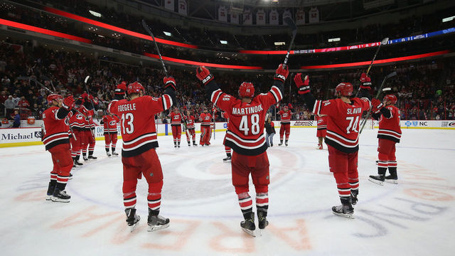 RALEIGH, NC - NOVEMBER 21: Jordan Martinook #48 of the Carolina Hurricanes celebrates with teammates following a victory over the Toronto Maple Leafs during an NHL game on November 21, 2018 at PNC Arena in Raleigh, North Carolina.
