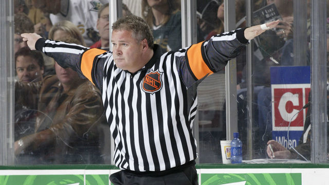 DALLAS - NOVEMBER 28: Referee Mick McGeough #19 signals no offsides during the game between the Dallas Stars and the New Jersey Devils at the American Airlines Center on November 28, 2003 in Dallas, Texas. The Stars defeated the Devils 2-0.
