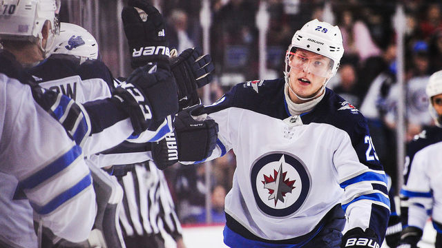 CALGARY, AB - NOVEMBER 21: Patrik Laine #29 of the Winnipeg Jets celebrates with the bench after scoring against the Calgary Flames during an NHL game at Scotiabank Saddledome on November 21, 2018 in Calgary, Alberta, Canada.