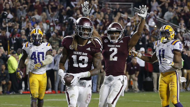 COLLEGE STATION, TEXAS - NOVEMBER 24: Kendrick Rogers #13 of the Texas A&M Aggies scores the winning two-point conversion in the seventh overtime period against the LSU Tigers as Jhamon Ausbon #2 celebrates as Devin White #40 of the LSU Tigers and Terrence Alexander #11 look on at Kyle Field on November 24, 2018 in College Station, Texas.