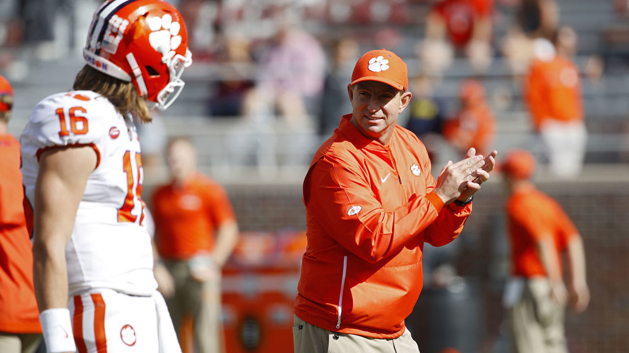 TALLAHASSEE, FL - OCTOBER 27: Head coach Dabo Swinney of the Clemson Tigers talks with quarterback Trevor Lawrence #16 before the game against the Florida State Seminoles at Doak Campbell Stadium on October 27, 2018 in Tallahassee, Florida. Clemson won 59-10.