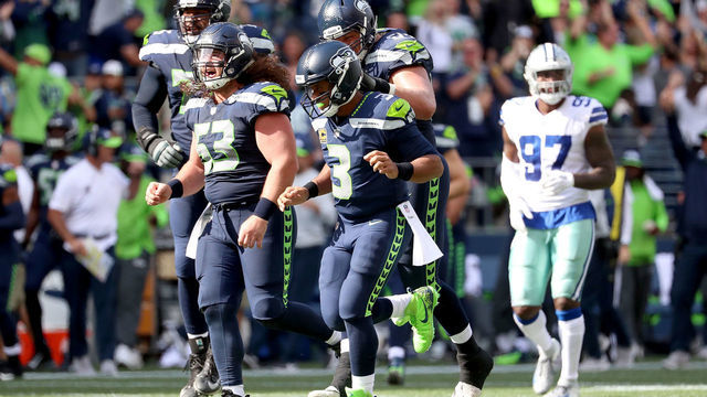 SEATTLE, WA - SEPTEMBER 23: Russell Wilson #3 of the Seattle Seahawks and teammates celebrate a touchdown by Tyler Lockett #16 of the Seattle Seahawks in the second quarter during their game at CenturyLink Field on September 23, 2018 in Seattle, Washington.