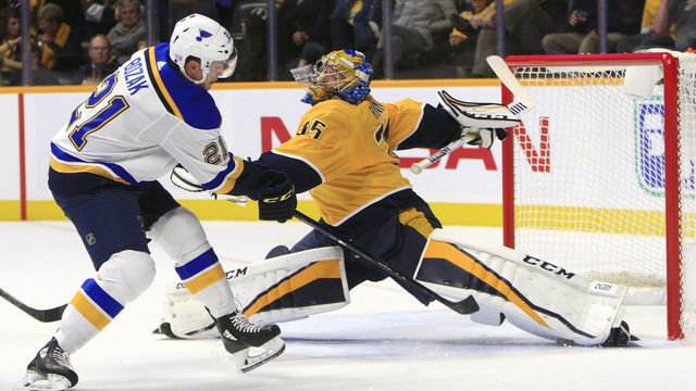 NASHVILLE, TN - NOVEMBER 21: Nashville Predators goalie Pekka Rinne (35) makes a save with his pad on St. Louis Blues center Tyler Bozak (21) during the NHL game between the Nashville Predators and St. Louis Blues, held on November 21, 2018, at Bridgestone Arena in Nashville, Tennessee.