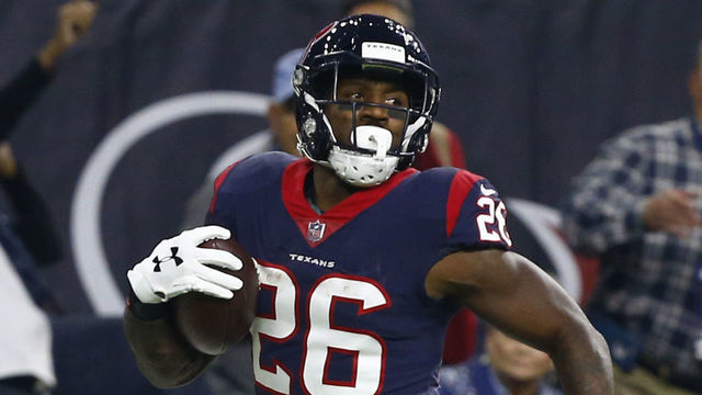 HOUSTON, TEXAS - NOVEMBER 26: Lamar Miller #26 of the Houston Texans looks back as he runs for a 97 yard touchdown during the second quarter against the Tennessee Titans at NRG Stadium on November 26, 2018 in Houston, Texas.