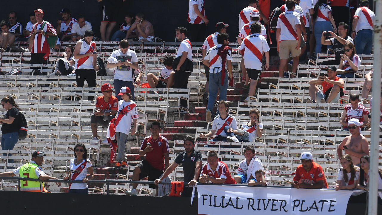 BUENOS AIRES, ARGENTINA - NOVEMBER 25: Fans of River Plate leave the stadium after the match was postponed for the second leg of the final of Copa CONMEBOL Libertadores 2018 between River Plate and Boca Juniors at Estadio Monumental Antonio Vespucio Liberti on November 25, 2018 in Buenos Aires, Argentina. The match was postponed again today due to the attacks suffered by players of Boca Juniors on their arrival to the stadium yesterday.