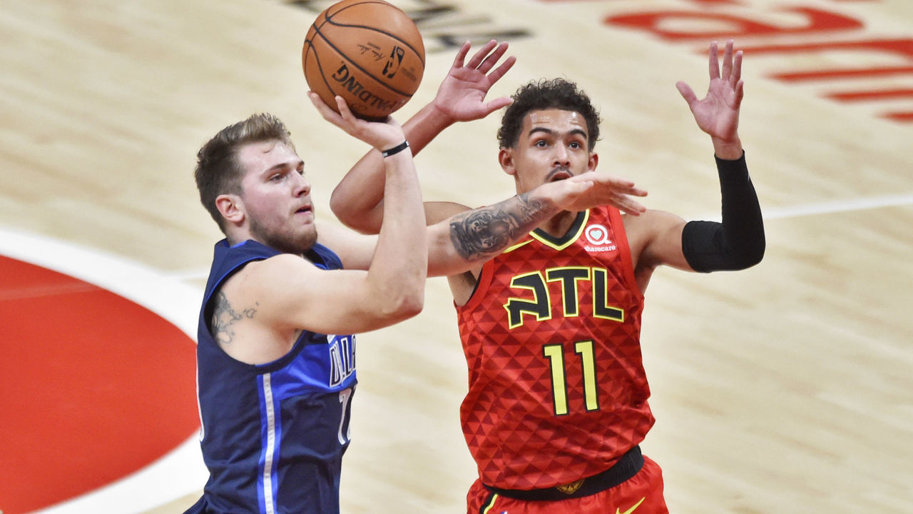 ATLANTA, GA - OCTOBER 24: Dallas Mavericks guard Luka Doncic (left) takes a shot against Atlanta Hawks guard Trae Young (11) during the first quarter of a NBA game on October 24, 2018 at State Farm Arena in Atlanta, GA.