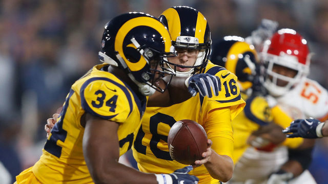 LOS ANGELES, CA - NOVEMBER 19: Jared Goff #16 of the Los Angeles Rams hands offsides to teammate Malcolm Brown #34 during the second quarter of the game against the Kansas City Chiefs at Los Angeles Memorial Coliseum on November 19, 2018 in Los Angeles, California.