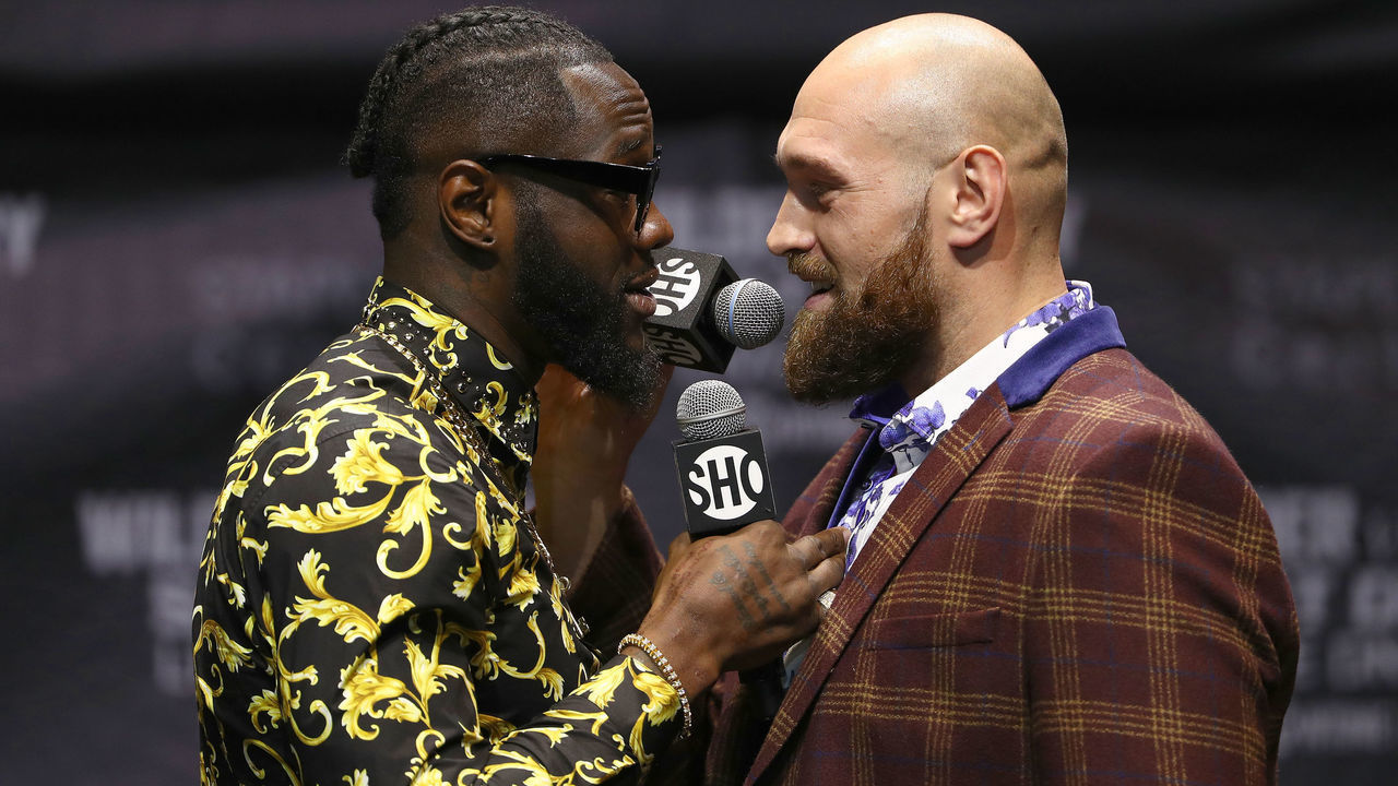 LOS ANGELES, CA - OCTOBER 03: Professional boxers Deontay Wilder (L) and Tyson Fury speak face-to-face onstage during a press conference to promote their upcoming December 1, 2018 fight in Los Angeles at The Novo by Microsoft on October 3, 2018 in Los Angeles, California.