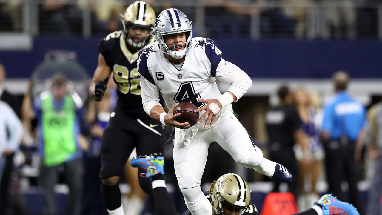 ARLINGTON, TEXAS - NOVEMBER 29: Dak Prescott #4 of the Dallas Cowboys runs the ball Cameron Jordan #94 of the New Orleans Saints in the second quarter at AT&T Stadium on November 29, 2018 in Arlington, Texas.