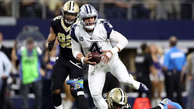 ARLINGTON, TEXAS - NOVEMBER 29: Dak Prescott #4 of the Dallas Cowboys runs the ball Cameron Jordan #94 of the New Orleans Saints in the second quarter at AT&T Stadium on November 29, 2018 in Arlington, Texas.