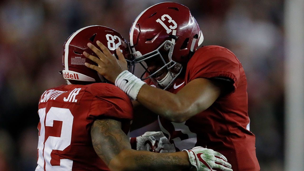 TUSCALOOSA, AL - NOVEMBER 24: Tua Tagovailoa #13 of the Alabama Crimson Tide reacts after passing for a touchdown to Henry Ruggs III #11 against the Auburn Tigers with Irv Smith Jr. #82 at Bryant-Denny Stadium on November 24, 2018 in Tuscaloosa, Alabama.