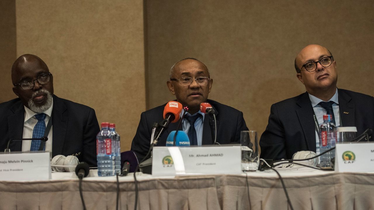 Vice President of the Confederation of African Football (CAF) Amaju Pinnink, President of CAF Ahmad Ahmad and Acting general secretary of CAF Essadik Alaoui look on during a press conference after an extraordinary meeting with CAF executives at the Kempinski Hotel in Accra on November 30, 2018. - Cameroon was on November 30, 2018 stripped of hosting the 2019 Africa Cup of Nations due to delays in preparing for the continental showpiece, organisers the Confederation of African Football announced. South Africa and Morocco are two frontline contenders to step in as hosts on place of the Cameroon, who won the last edition in 2017 in Gabon.