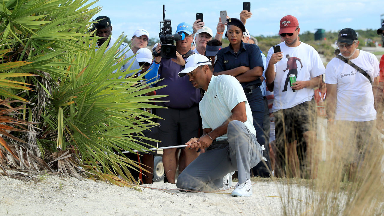NASSAU, BAHAMAS - NOVEMBER 30: Tiger Woods of the United States sets up to play his second shot from the edge of a bush on the 18th hole during the second round of the 2018 Hero World Challenge at Albany Bahamas on November 30, 2018 in Nassau, Bahamas.