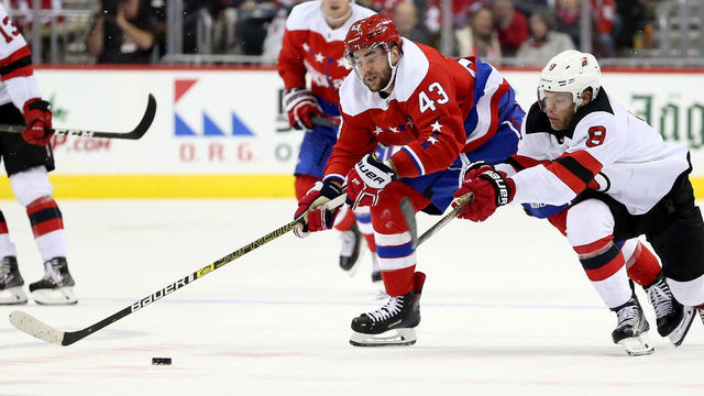 WASHINGTON, DC - NOVEMBER 30: Tom Wilson #43 of the Washington Capitals and Will Butcher #8 of the New Jersey Devils go after the puck during the second period at Capital One Arena on November 30, 2018 in Washington, DC.