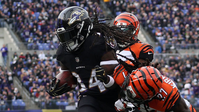 BALTIMORE, MD - NOVEMBER 18: Running Back Alex Collins #34 of the Baltimore Ravens rushes for a touchdown in the first quarter against the Cincinnati Bengals at M&T Bank Stadium on November 18, 2018 in Baltimore, Maryland.