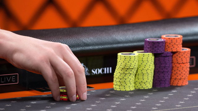 SOCHI, RUSSIA - AUGUST 10, 2018: A person holding poker chips during a poker round as part of the Millions Russia poker tournament with the record-breaking guaranteed prize pool of $9 million, at the Sochi Casino and Resort. Artur Lebedev/TASS