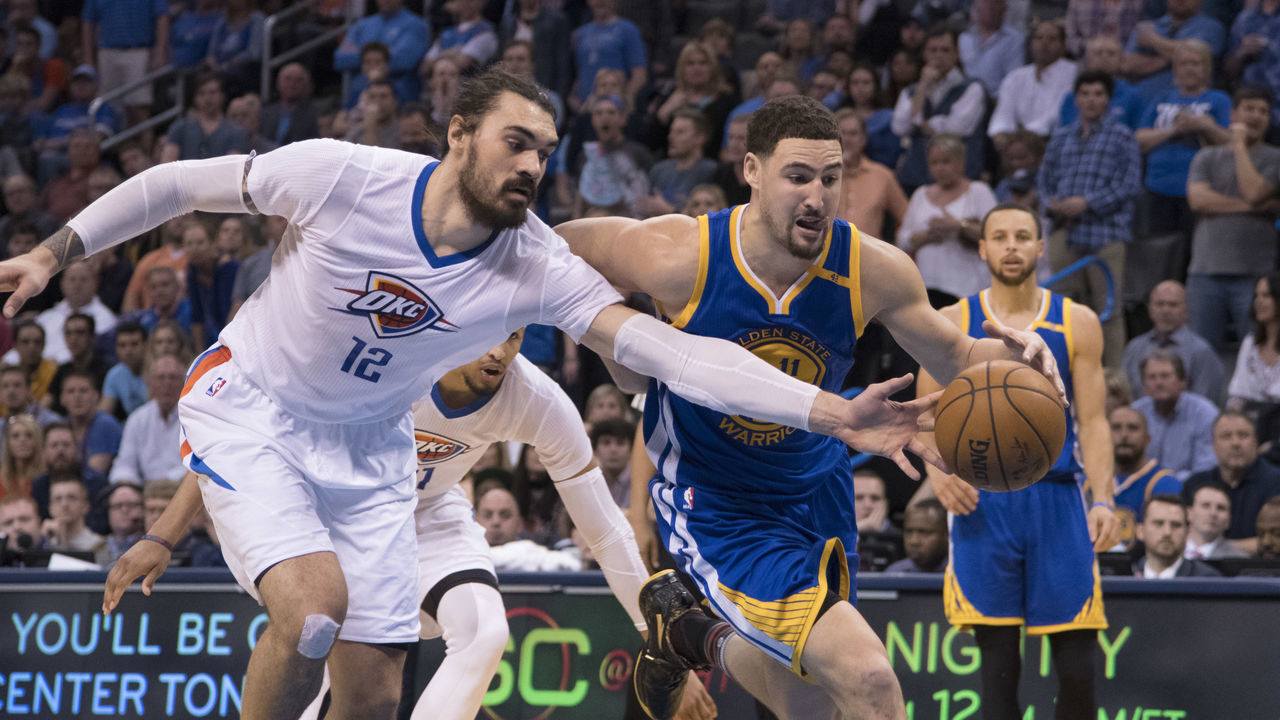 OKLAHOMA CITY, OK - FEBRUARY 11: Steven Adams #12 of the Oklahoma City Thunder and Klay Thompson #11 of the Golden State Warriors battle for the ball during the second half of a NBA game at the Chesapeake Energy Arena on February 11, 2017 in Oklahoma City, Oklahoma.