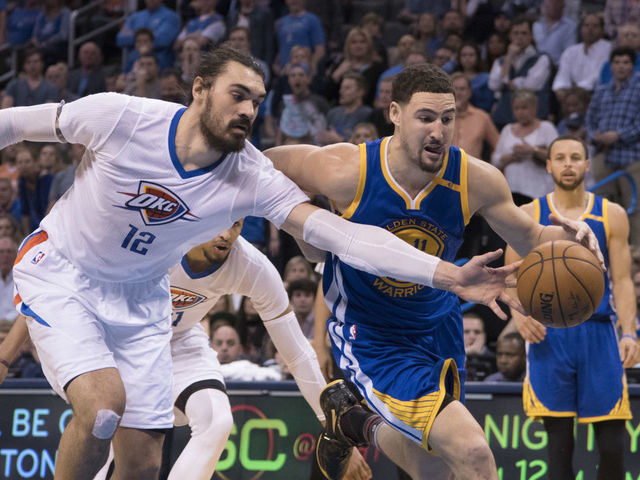 OKLAHOMA CITY, OK - FEBRUARY 11: Steven Adams #12 of the Oklahoma City Thunder and Klay Thompson #11 of the Golden State Warriors battle for the ball during the second half of a NBA game at the Chesapeake Energy Arena on February 11, 2017 in Oklahoma City, Oklahoma.