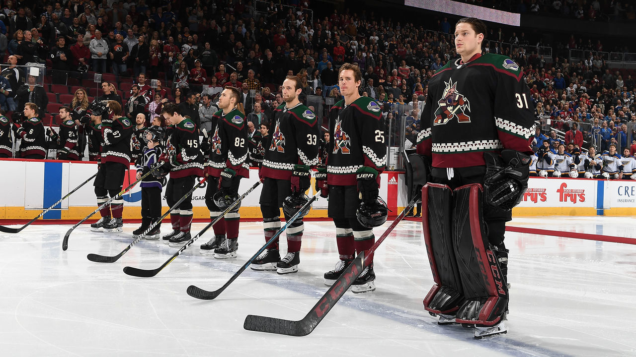 GLENDALE, AZ - DECEMBER 01: Goalie Adin Hill #31 and Nick Cousins #25 of the Arizona Coyotes stand on the blue line with teammates prior to a game against the St Louis Blues at Gila River Arena on December 1, 2018 in Glendale, Arizona.