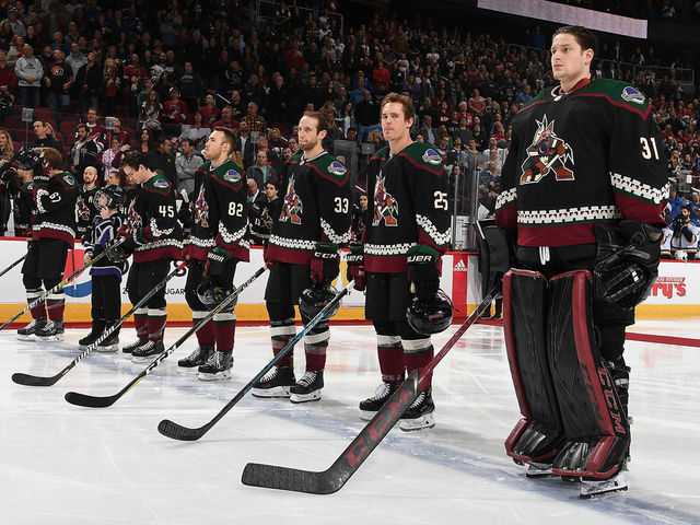 GLENDALE, AZ - DECEMBER 01: Goalie Adin Hill #31 and Nick Cousins #25 of the Arizona Coyotes stand on the blue line with teammates prior to a game against the St Louis Blues at Gila River Arena on December 1, 2018 in Glendale, Arizona.