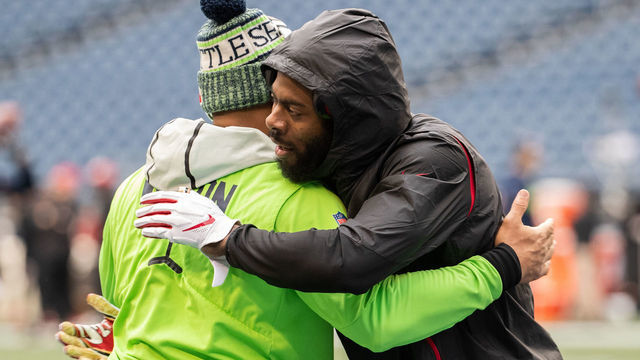 SEATTLE, WA - DECEMBER 02: Richard Sherman #25 of the San Francisco 49ers hugs Russell Wilson #3 of the Seattle Seahawks during pre-game warmups at CenturyLink Field on December 2, 2018 in Seattle, Washington.