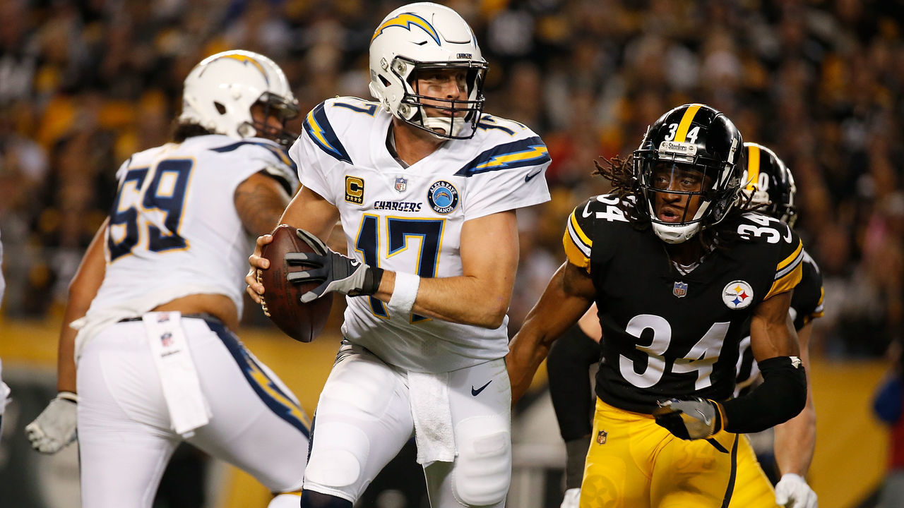PITTSBURGH, PA - DECEMBER 02: Philip Rivers #17 of the Los Angeles Chargers scrambles under pressure from Terrell Edmunds #34 of the Pittsburgh Steelers in the first half during the game at Heinz Field on December 2, 2018 in Pittsburgh, Pennsylvania.