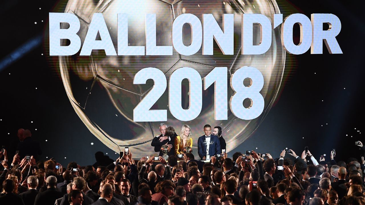2018 FIFA Ballon d'Or awarded for best player of the year, Men's Ballon d'Or Real Madrid's Croatian midfielder Luka Modric (2ndL) is congratulated by former French footballer and host David Ginola (L) past Women's Ballon d'Or Olympique Lyonnais' Norwegian forward Ada Hegerberg (C) and Under-21 Ballon d'Or (Kopa trophy) Paris Saint-Germain's French forward Kylian Mbappe (2ndR) at the end of the 2018 FIFA Ballon d'Or award ceremony at the Grand Palais in Paris on December 3, 2018. - The winner of the 2018 Ballon d'Or will be revealed at a glittering ceremony in Paris on December 3 evening, with Croatia's Luka Modric and a host of French World Cup winners all hoping to finally end the 10-year duopoly of Cristiano Ronaldo and Lionel Messi.