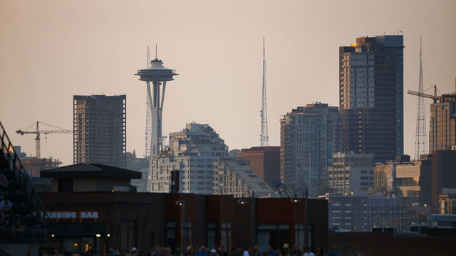 SEATTLE, WA - JULY 30: Part of the downtown Seattle skyline, including the Space Needle, is seen as the sun begins to set over Safeco Field during the game between the Seattle Mariners and the Houston Astros on July 30, 2018 in Seattle, Washington. The Seattle Mariners beat the Houston Astros 2-0.
