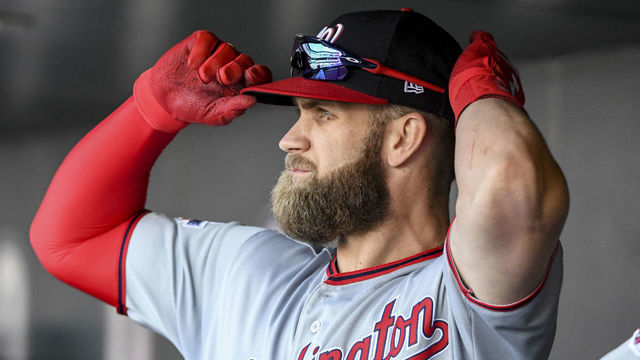 DENVER, CO - SEPTEMBER 30: Washington Nationals right fielder Bryce Harper (34) adjusts his hat before taking the field during the final regular season game of the 2018 season against the Colorado Rockies at Coors Field.