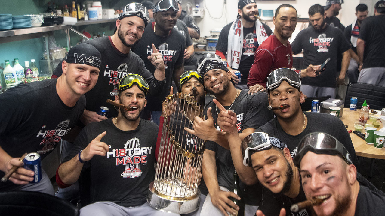 LOS ANGELES, CA - OCTOBER 28: Bobby Poyner #11, Steve Pearce #25, J.D. Martinez #28, Edaurdo Nunez #36, Xander Bogaerts #2, Mookie Betts #50, Rafael Devers #11, Eduardo Rodriguez #57, and Christian Vazquez #7 of the Boston Red Sox celebrate with the World Series trophy in the clubhouse after winning the 2018 World Series in game five of the 2018 World Series against the Los Angeles Dodgers on October 28, 2018 at Dodger Stadium in Los Angeles, California.