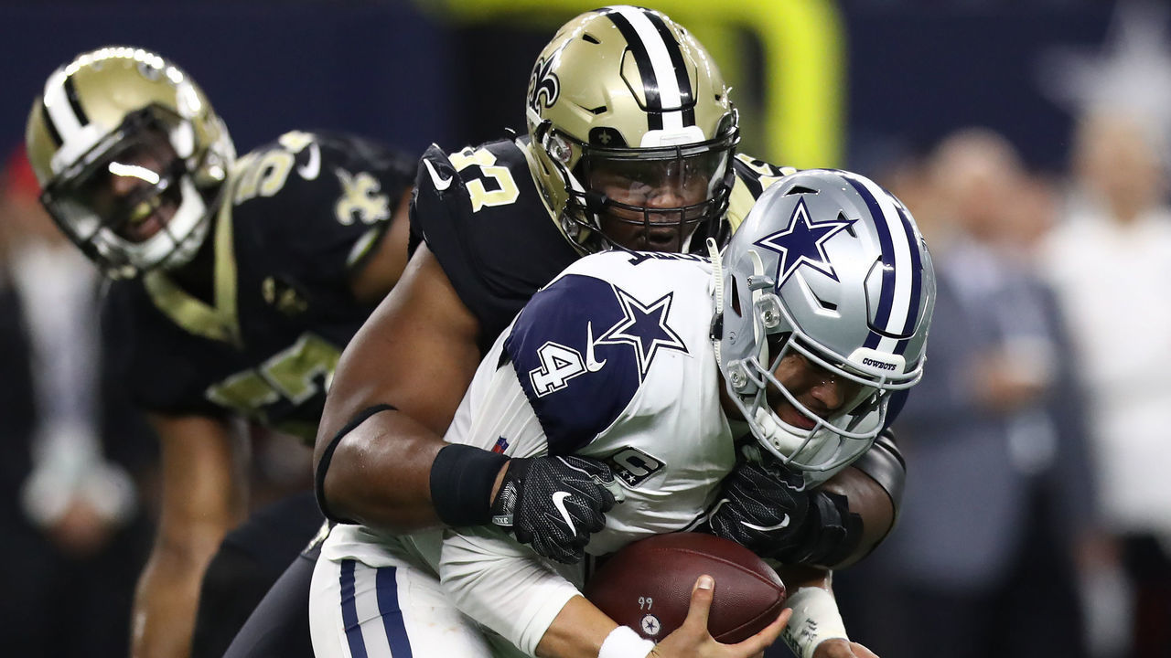 ARLINGTON, TEXAS - NOVEMBER 29: Dak Prescott #4 of the Dallas Cowboys is sacked by David Onyemata #93 of the New Orleans Saints in the first quarter at AT&T Stadium on November 29, 2018 in Arlington, Texas.