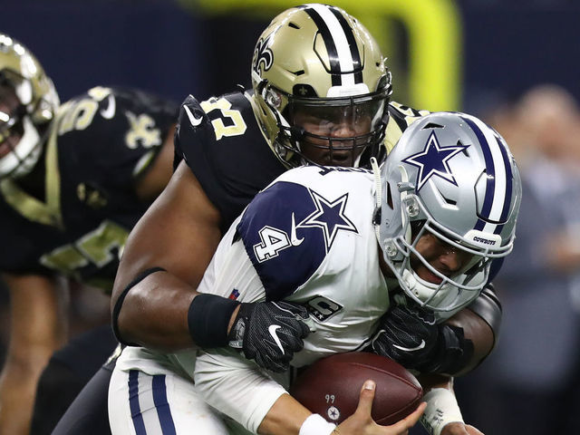 ARLINGTON, TEXAS - NOVEMBER 29: Dak Prescott #4 of the Dallas Cowboys is sacked by David Onyemata #93 of the New Orleans Saints in the first quarter at AT&T Stadium on November 29, 2018 in Arlington, Texas.