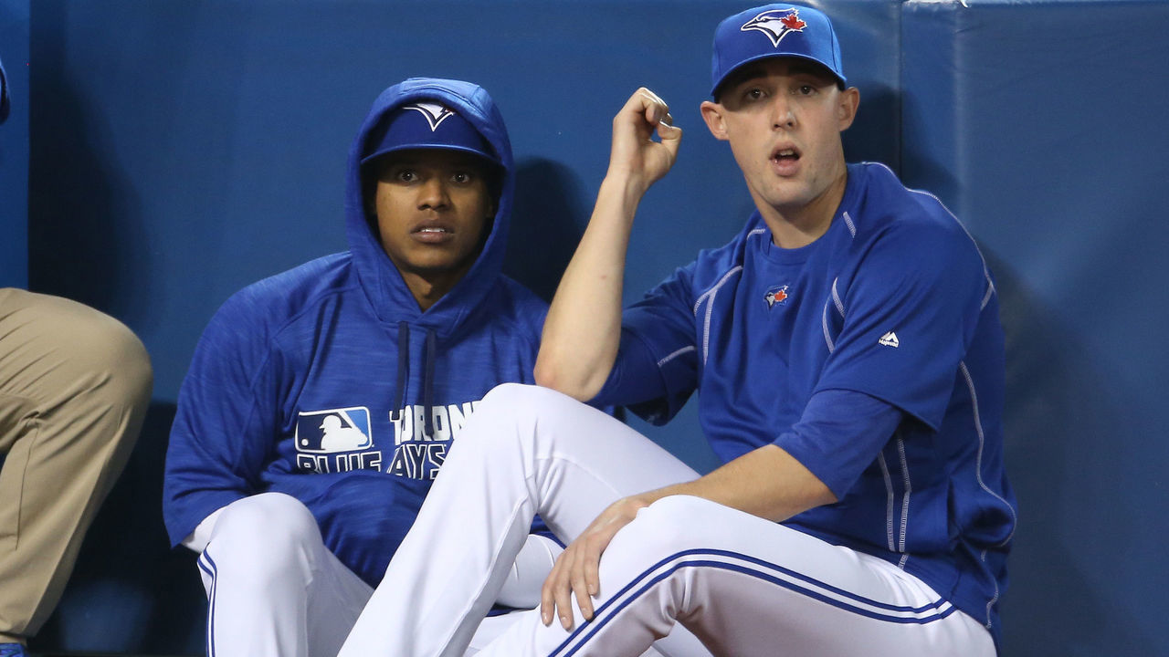 TORONTO, CANADA - APRIL 9: Marcus Stroman #6 of the Toronto Blue Jays and Aaron Sanchez #41 look on from the top step of the dugout during MLB game action against the Boston Red Sox on April 9, 2016 at Rogers Centre in Toronto, Ontario, Canada.