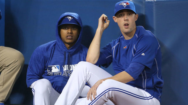 TORONTO, CANADA - APRIL 9: Marcus Stroman #6 of the Toronto Blue Jays and Aaron Sanchez #41 look on from the top step of the dugout during MLB game action against the Boston Red Sox on April 9, 2016 at Rogers Centre in Toronto, Ontario, Canada.