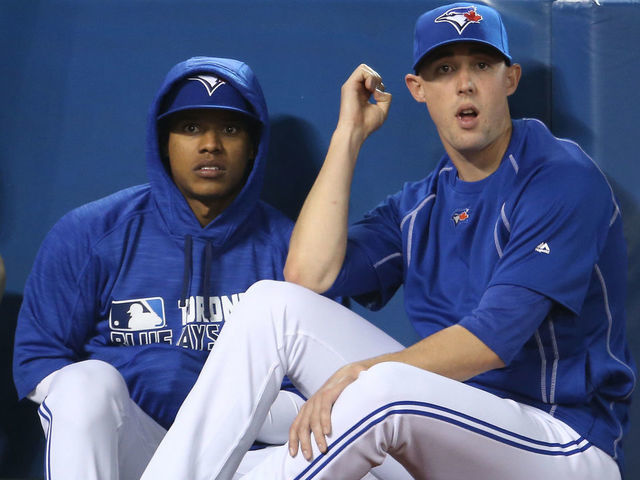 TORONTO, CANADA - APRIL 9: Marcus Stroman #6 of the Toronto Blue Jays and Aaron Sanchez #41 look on from the top step of the dugout during MLB game action against the Boston Red Sox on April 9, 2016 at Rogers Centre in Toronto, Ontario, Canada.