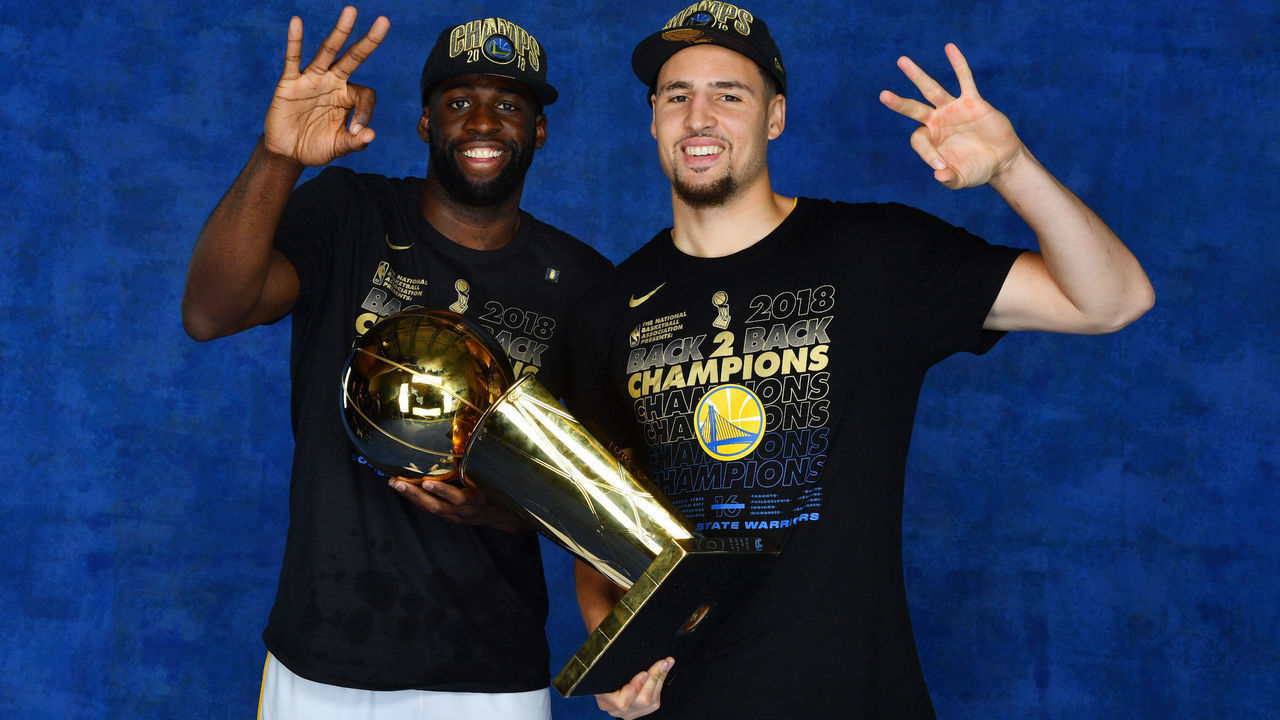 CLEVELAND, OH - JUNE 8: Draymond Green #23 and Klay Thompson #11 of the Golden State Warriors pose for a portrait with the Larry O'Brien Championship trophy after defeating the Cleveland Cavaliers in Game Four of the 2018 NBA Finals on June 8, 2018 at Quicken Loans Arena in Cleveland, Ohio. NOTE TO USER: User expressly acknowledges and agrees that, by downloading and/or using this Photograph, user is consenting to the terms and conditions of the Getty Images License Agreement. Mandatory Copyright Notice: Copyright 2018 NBAE