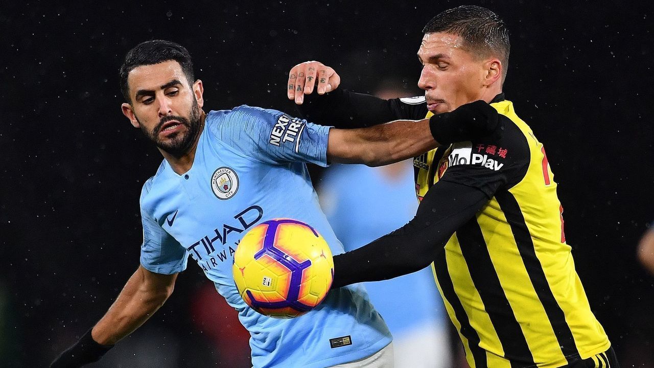 Manchester City's Algerian midfielder Riyad Mahrez (L) voes with Watford's German-born Greek midfielder Jose Holebas during the English Premier League football match between Watford and Manchester City at Vicarage Road Stadium in Watford, north of London on December 4, 2018.