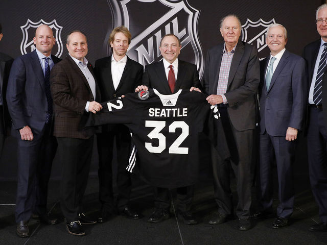 SEA ISLAND, GA - DECEMBER 04: (L to R) Adrian Hanauer, NHL Seattle franchise Vice-Chairman David Wright, Jay Deutsch, Jerry Bruckheimer, NHL Commissioner Gary Bettman, NHL Seattle franchise majority owner David Bonderman, Len Potter, and NHL Seattle franchise President and CEO Tod Leiweke pose for a photo during the NHL Board of Governors Meeting on December 4, 2018 in Sea Island, Georgia. The NHL Board of Governors approved expanding to Seattle, making the franchise the 32nd team in the league.
