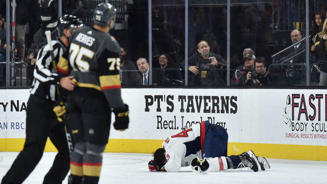 LAS VEGAS, NV - DECEMBER 4: Tom Wilson #43 of the Washington Capitals lays on the ices after a hit by Ryan Reaves #75 of the Vegas Golden Knights during the second period of a game at T-Mobile Arena on December 4, 2018 in Las Vegas, Nevada.