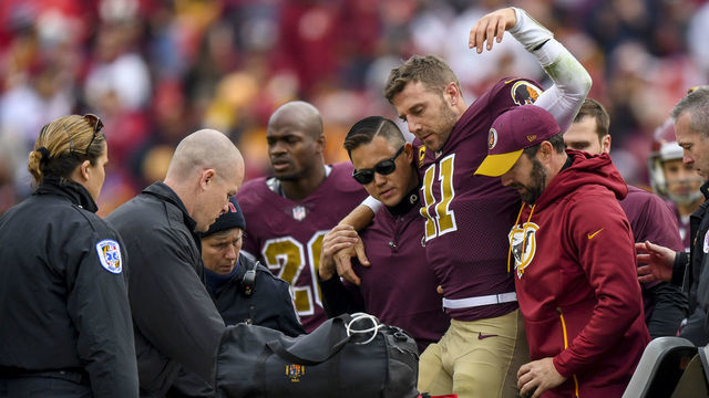 LANDOVER, MD - NOVEMBER 18: Washington Redskins quarterback Alex Smith (11) is lifted up to be carted off the field in a game between the Washington Redskins and the Houston Texans at FedEx Field on, November 18, 2018.
