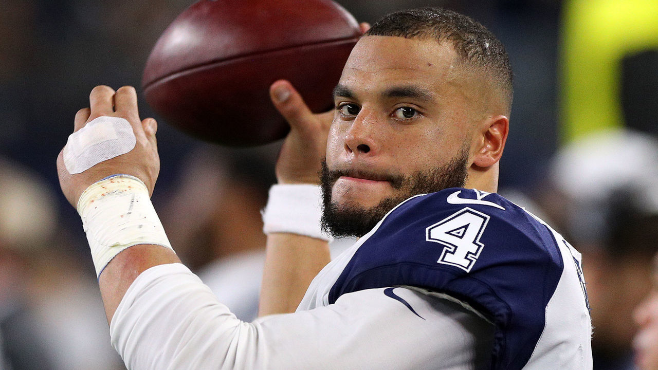 ARLINGTON, TEXAS - NOVEMBER 29: Dak Prescott #4 of the Dallas Cowboys throws passws on the sidelines during a New Orleans Saints possession in the first quarter at AT&T Stadium on November 29, 2018 in Arlington, Texas.
