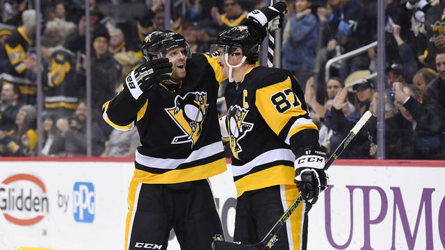 PITTSBURGH, PA - DECEMBER 06: Pittsburgh Penguins Right Wing Phil Kessel (81) celebrates his second goal of the game with Pittsburgh Penguins Center Sidney Crosby (87) during the second period in the NHL game between the Pittsburgh Penguins and the New York Islanders on December 6, 2018, at PPG Paints Arena in Pittsburgh, PA.