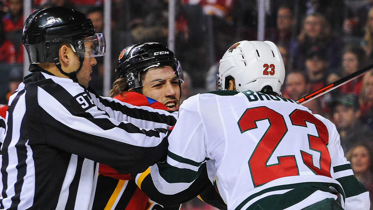 CALGARY, AB - DECEMBER 6: Ryan Lomberg #56 of the Calgary Flames shoves J.T. Brown #23 of the Minnesota Wild after the whistle during an NHL game at Scotiabank Saddledome on December 6, 2018 in Calgary, Alberta, Canada.