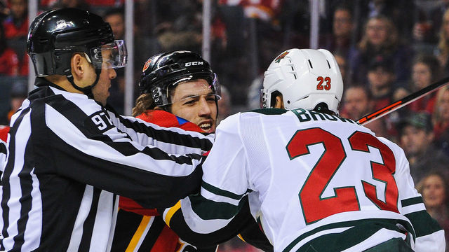 CALGARY, AB - DECEMBER 6: Ryan Lomberg #56 of the Calgary Flames shoves J.T. Brown #23 of the Minnesota Wild after the whistle during an NHL game at Scotiabank Saddledome on December 6, 2018 in Calgary, Alberta, Canada.