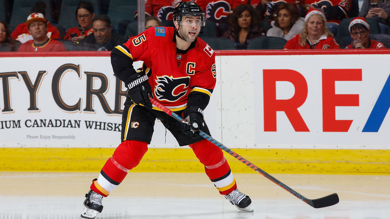CALGARY, AB - NOVEMBER 30: Mark Giordano #5 of the Calgary Flames plays the puck against the Los Angeles Kings at Scotiabank Saddledome on November 30, 2018 in Calgary, Alberta, Canada.