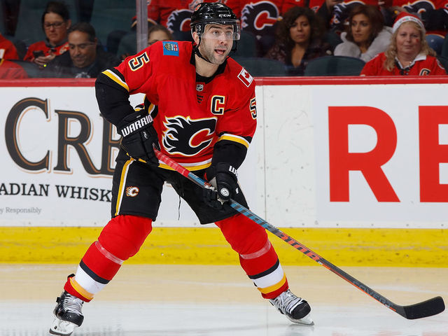 CALGARY, AB - NOVEMBER 30: Mark Giordano #5 of the Calgary Flames plays the puck against the Los Angeles Kings at Scotiabank Saddledome on November 30, 2018 in Calgary, Alberta, Canada.