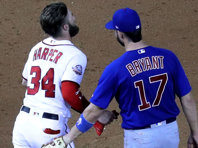 WASHINGTON, DC - SEPTEMBER 6: Bryce Harper #34 of the Washington Nationals talks with Kris Bryant #17 of the Chicago Cubs at Nationals Park on September 6, 2018 in Washington, DC.