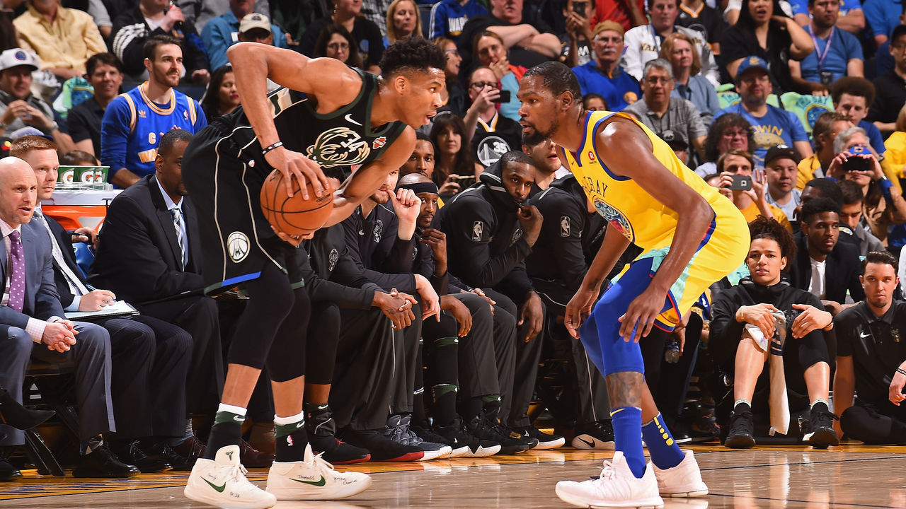 OAKLAND, CA - MARCH 29: Giannis Antetokounmpo #34 of the Milwaukee Bucks handles the ball against Kevin Durant #35 of the Golden State Warriors on March 29, 2018 at ORACLE Arena in Oakland, California. NOTE TO USER: User expressly acknowledges and agrees that, by downloading and/or using this photograph, user is consenting to the terms and conditions of Getty Images License Agreement. Mandatory Copyright Notice: Copyright 2018 NBAE