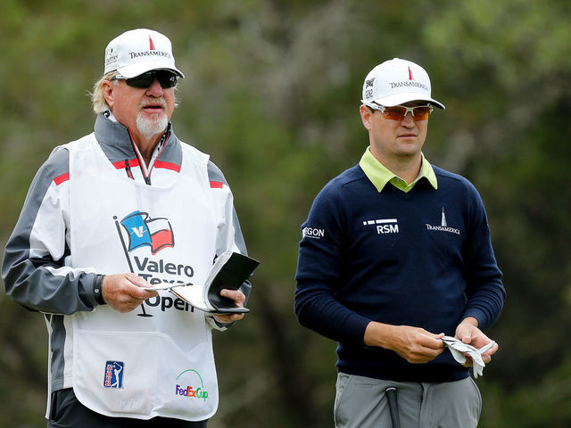 SAN ANTONIO, TX - APRIL 20: Zach Johnson talks with his caddie on the fifth hole during the second round of the Valero Texas Open at TPC San Antonio AT&T Oaks Course on April 19, 2018 in San Antonio, Texas.