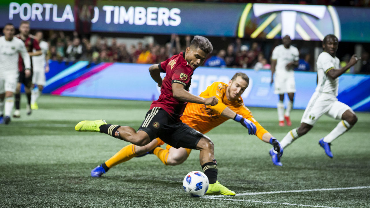 ATLANTA, GA - DECEMBER 08: Josef Martinez #7 of Atlanta United takes the ball past goalkeeper Jeff Attinella #1 of Portland Timbers for the 1st goal of the match in the 1st half of the 2018 Audi MLS Cup Championship match between Atlanta United and the Portland Timbers at the Mercedes Benz Stadium on December 08, 2018 in Atlanta, GA.